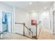 Bright hallway with carpeted floors, white trim, and a view of the staircase and upstairs landing at 40 Two Creeks Loop, Chapel Hill, NC 27517
