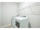 Clean laundry room features a washer, dryer, and wire rack shelving for storage at 40 Two Creeks Loop, Chapel Hill, NC 27517
