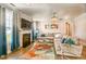 Cozy living room featuring a fireplace, a large sectional sofa, and a decorative chandelier at 40 Two Creeks Loop, Chapel Hill, NC 27517