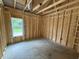 Framed bedroom featuring exposed wood and under-construction details with a window letting in light at 4024 N Nc 581 Hwy, Kenly, NC 27542