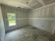 Empty bedroom with drywall, a single window, and visible construction dust at 4024 N Nc 581 Hwy, Kenly, NC 27542