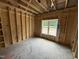 Framed bedroom featuring exposed wood and unfinished details, and a window for plenty of natural light at 4024 N Nc 581 Hwy, Kenly, NC 27542