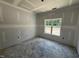 New bedroom featuring a single window, sheetrocked walls and ceilings, and bare concrete floors at 4024 N Nc 581 Hwy, Kenly, NC 27542