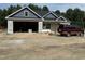 New construction home featuring blue and gray exterior, an attached garage, and professional landscaping at 4024 N Nc 581 Hwy, Kenly, NC 27542