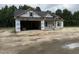 A new home under construction featuring an open two-car garage and a covered front porch at 4024 N Nc 581 Hwy, Kenly, NC 27542