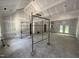 Spacious living room under construction featuring tall ceilings, drywall, and scaffolding at 4024 N Nc 581 Hwy, Kenly, NC 27542