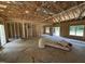 A spacious room with framing and rough concrete floors; this home is ready for customization at 4024 N Nc 581 Hwy, Kenly, NC 27542