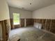 Room under construction, featuring insulation, drywall work, and a large window at 4024 N Nc 581 Hwy, Kenly, NC 27542