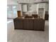 Spacious kitchen renovation with modern island, white upper cabinets, and gray lower cabinets at 4035 King Charles Rd, Durham, NC 27707