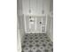 Unfinished laundry room features patterned tile floor and white cabinets at 4035 King Charles Rd, Durham, NC 27707