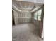 Living room with drywall, tray ceiling, and a window letting in natural light, showcasing a spacious and bright interior at 4035 King Charles Rd, Durham, NC 27707