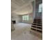 Living room with a fireplace, staircase, and natural light from the windows, creating an inviting atmosphere at 4035 King Charles Rd, Durham, NC 27707