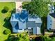 Aerial view of the property showcasing the house layout, backyard patio, and surrounding lush landscaping at 405 Culvert St, Apex, NC 27502