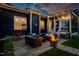 Cozy backyard patio with comfortable seating, a fire pit, ambient lighting, and a barbecue grill at 405 Culvert St, Apex, NC 27502