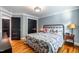Charming bedroom featuring hardwood floors, a metal frame bed and stylish decor at 405 Culvert St, Apex, NC 27502