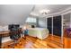 Comfortable bedroom with hardwood floors, a desk area, and natural light from the window at 405 Culvert St, Apex, NC 27502