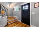 Welcoming entryway with wood floors, stairs, and a modern black front door at 405 Culvert St, Apex, NC 27502