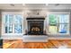 Elegant fireplace featuring a decorative mantle with windows on either side allowing natural light at 405 Culvert St, Apex, NC 27502