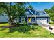 Charming two-story blue home with a bright yellow front door and well-manicured lawn at 405 Culvert St, Apex, NC 27502