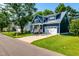 Charming blue two-story home featuring a yellow front door, manicured lawn and white trim at 405 Culvert St, Apex, NC 27502