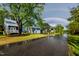 Charming two-story house with a double rainbow, a lush lawn, and street flooded after heavy rain at 405 Culvert St, Apex, NC 27502