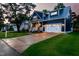 Beautiful two-story home featuring an attached garage, welcoming porch, and well-manicured lawn at dusk at 405 Culvert St, Apex, NC 27502