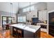 Spacious kitchen with vaulted ceilings, custom cabinets, large island, stainless appliances and hardwood floors at 405 Culvert St, Apex, NC 27502