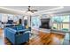 Bright, open living room with modern finishes, hardwood floors and a stylish blue sectional sofa at 405 Culvert St, Apex, NC 27502