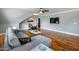 Comfortable living room with hardwood floors, sleeper sofa, and stylish table; also features a television at 405 Culvert St, Apex, NC 27502