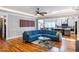 Bright, open living room with modern finishes, hardwood floors and a stylish blue sectional sofa at 405 Culvert St, Apex, NC 27502