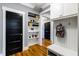 Well-organized mud room with built-in shelving, coat hooks, and a bench at 405 Culvert St, Apex, NC 27502