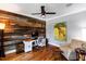 Home office featuring rustic wood wall and hardwood floors at 405 Culvert St, Apex, NC 27502