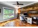 Home office featuring rustic wood wall and hardwood floors at 405 Culvert St, Apex, NC 27502