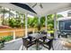 Cozy screened-in porch with a dining table, chairs, and view of the backyard at 405 Culvert St, Apex, NC 27502