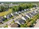 A neighborhood aerial view with houses, tree lines, a small lake and manicured lawns at 427 Cedar Pond Ct, Knightdale, NC 27545