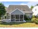 Gray home exterior with a screened-in porch and lush green backyard at 427 Cedar Pond Ct, Knightdale, NC 27545
