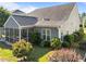 Beautiful gray home exterior with a screened-in porch and lush green backyard at 427 Cedar Pond Ct, Knightdale, NC 27545
