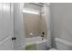 Cozy bathroom showcasing a bathtub with a shower curtain, tiled walls, and a window at 427 Cedar Pond Ct, Knightdale, NC 27545