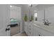 Bathroom featuring double sinks, white cabinetry, and a view into the bedroom at 427 Cedar Pond Ct, Knightdale, NC 27545