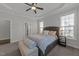 Spacious primary bedroom with a ceiling fan, large windows, and a padded bench at the foot of the bed at 427 Cedar Pond Ct, Knightdale, NC 27545