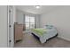 Comfortable bedroom with a bed, dresser, large window with blinds and curtains at 427 Cedar Pond Ct, Knightdale, NC 27545