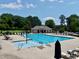 A community pool featuring lounge chairs, umbrellas, and a wading pool for children to enjoy at 427 Cedar Pond Ct, Knightdale, NC 27545