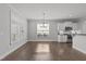 An open dining area next to the kitchen has hardwood floors and abundant natural light from a large picture window at 427 Cedar Pond Ct, Knightdale, NC 27545