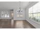 Spacious dining area featuring hardwood floors, a modern chandelier, and windows that let in natural light at 427 Cedar Pond Ct, Knightdale, NC 27545
