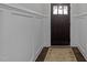 Elegant foyer with dark wood floors, wainscoting, and a stylish front door with glass accents at 427 Cedar Pond Ct, Knightdale, NC 27545