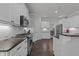 Modern kitchen with stainless steel appliances, white cabinetry, and a subway tile backsplash with bar seating at 427 Cedar Pond Ct, Knightdale, NC 27545