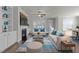 Bright living room featuring built-in shelving, a cozy fireplace, and comfortable seating with blue accents at 427 Cedar Pond Ct, Knightdale, NC 27545