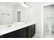 Bright bathroom featuring a double sink vanity with modern fixtures and a large mirror at 513 Basin Hill Dr, Wake Forest, NC 27587