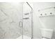 Bathroom featuring a glass shower with marble patterned tile and minimalist decor at 513 Basin Hill Dr, Wake Forest, NC 27587