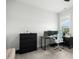 Bedroom with a modern desk setup, black dresser and a large window at 513 Basin Hill Dr, Wake Forest, NC 27587